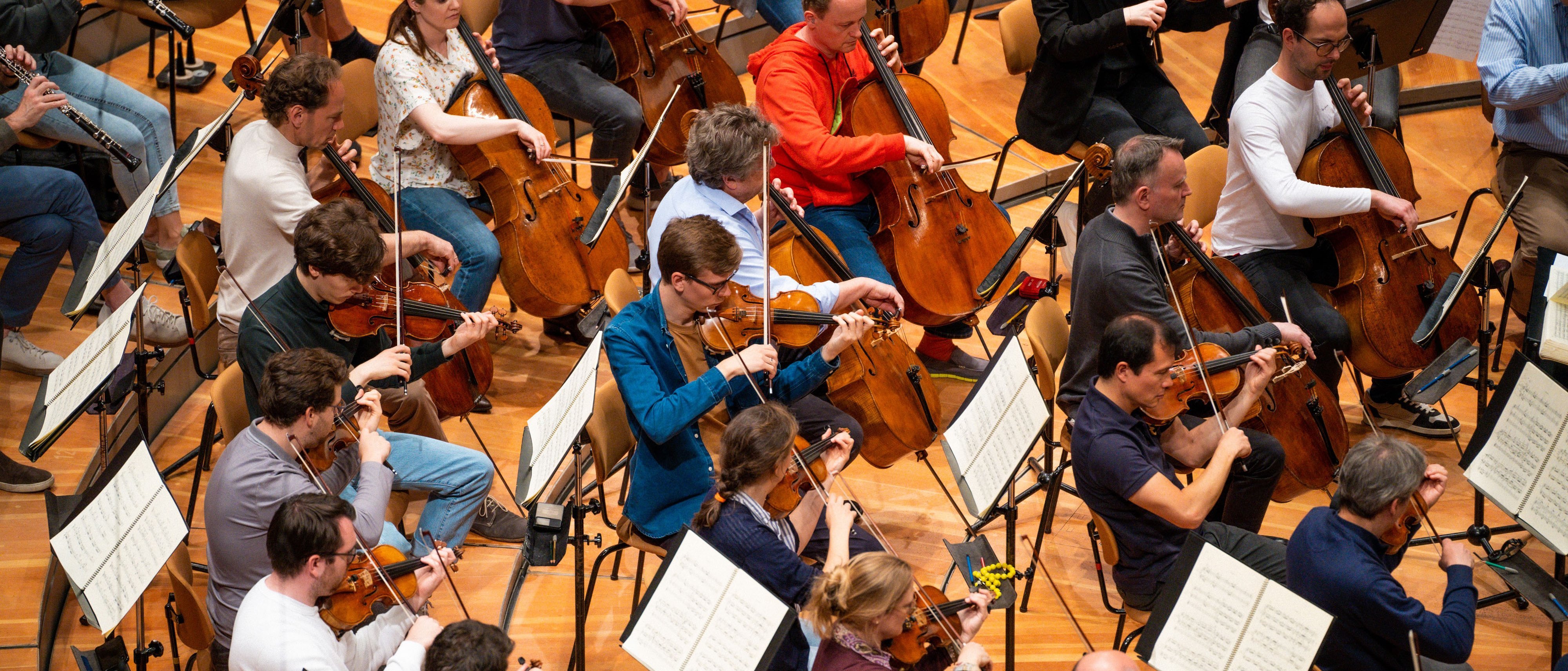 Group of musicians in the orchestra playing music at a rehearsal