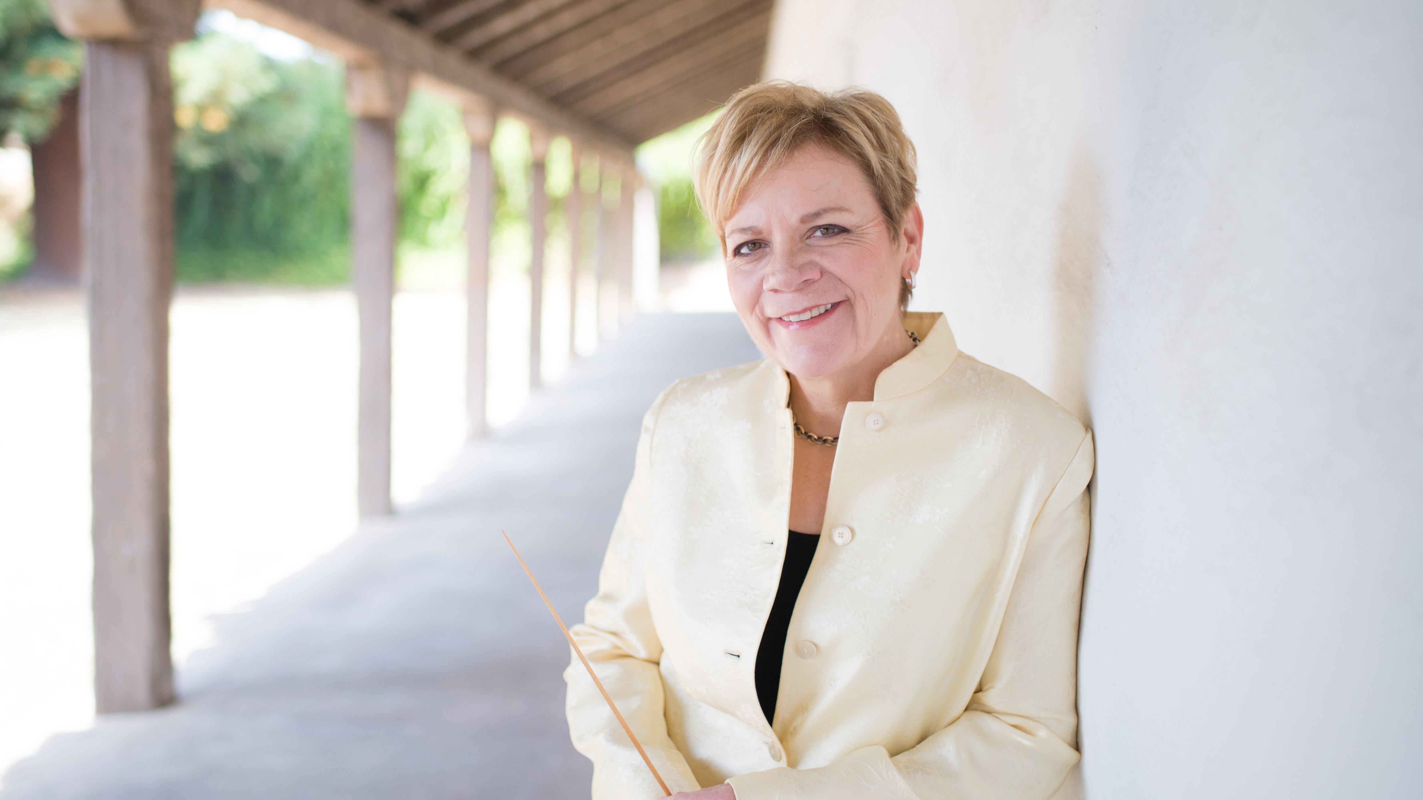 Marin Alsop leaning against a wall