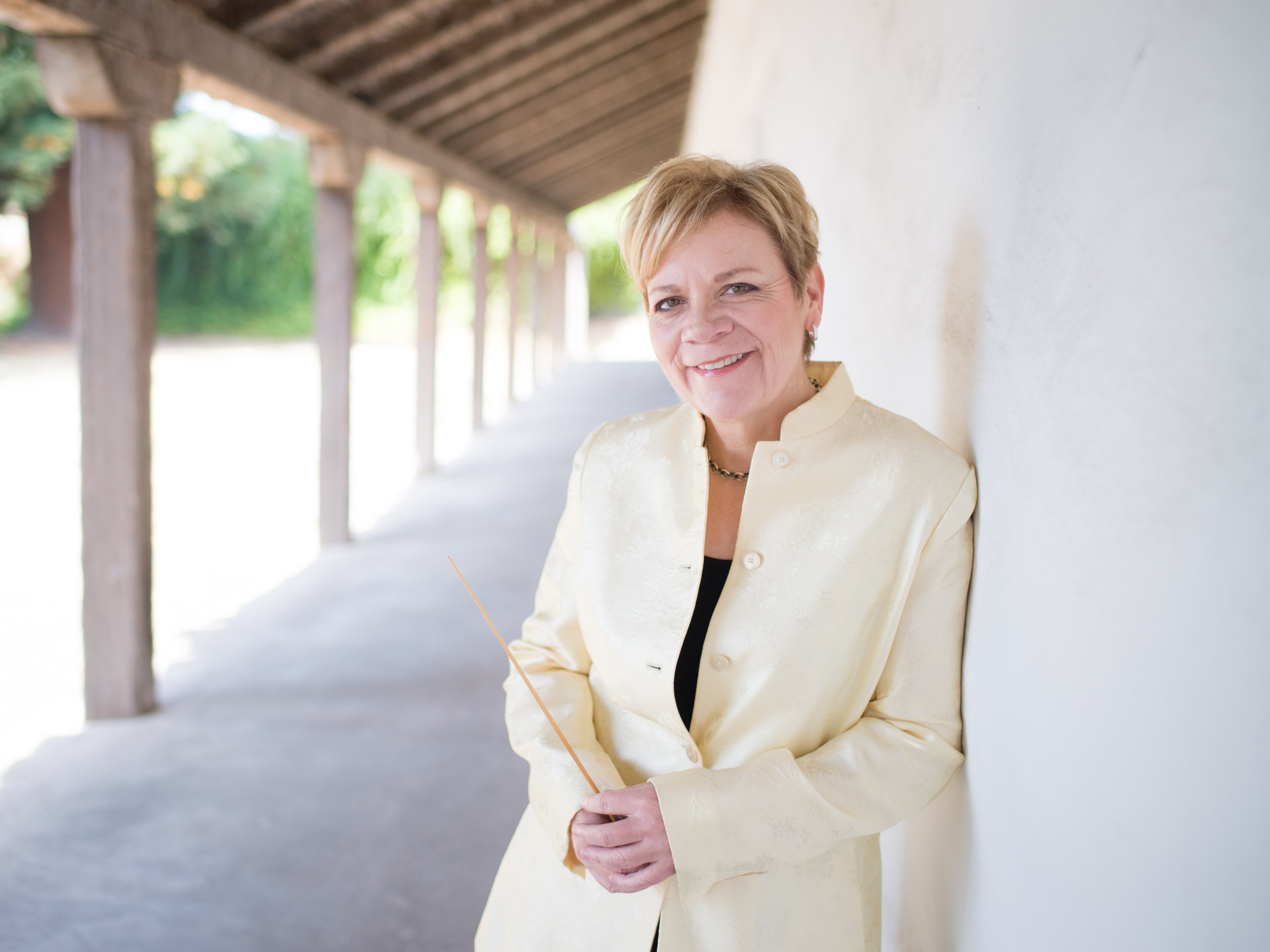 Marin Alsop leaning against a wall