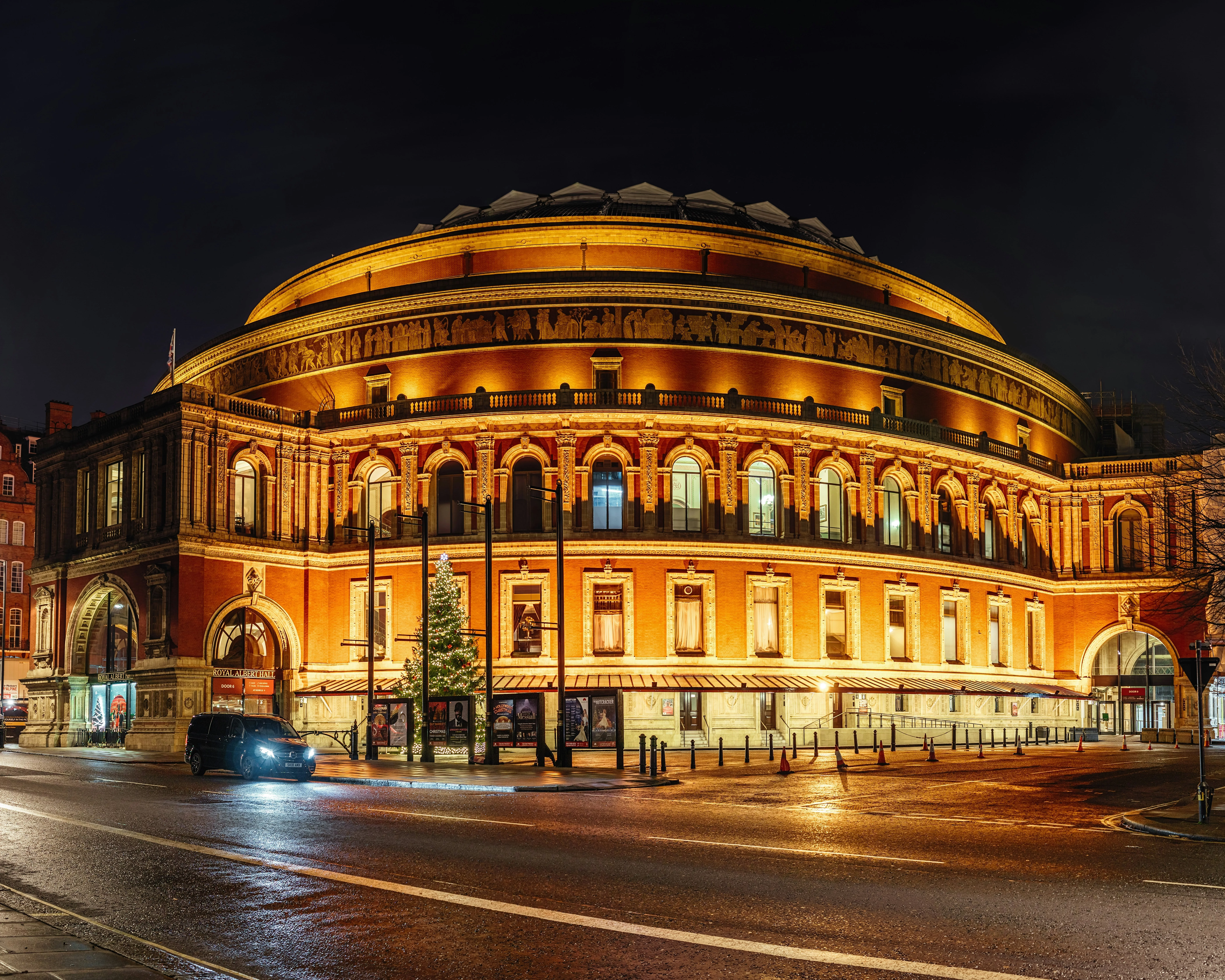 A large building with a dome roof, with the Royal Albert Hall in the background.